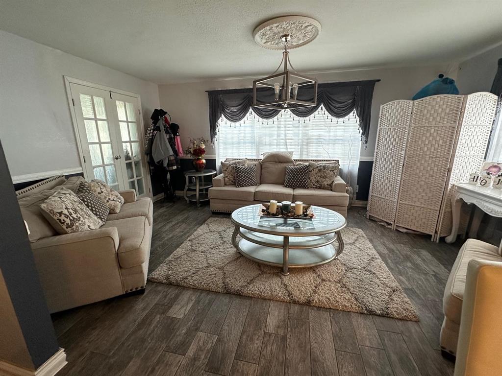 A living room features beige sofas, a glass coffee table, and a grey area rug — 4612 MESA VERDE DRIVE, ST CLOUD, FL