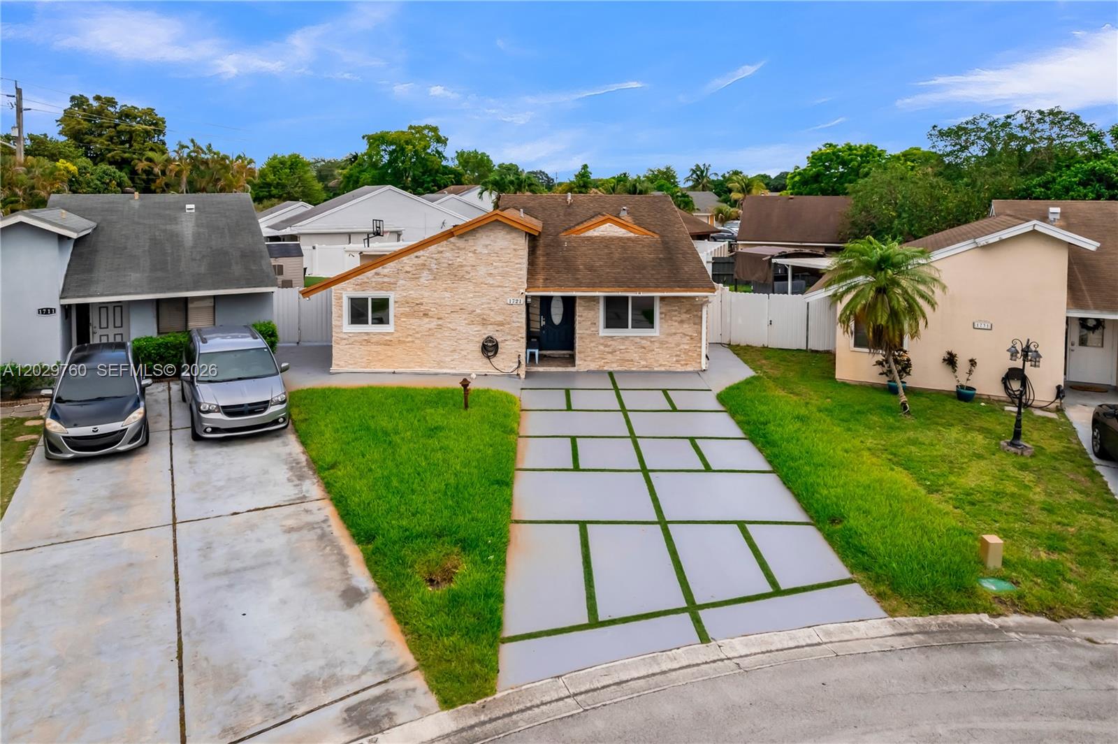 A single-story house with a stone facade and a modern paved driveway with grass strips — 1721 SW 87th Ter, Miramar FL 33025, MIRAMAR, FL