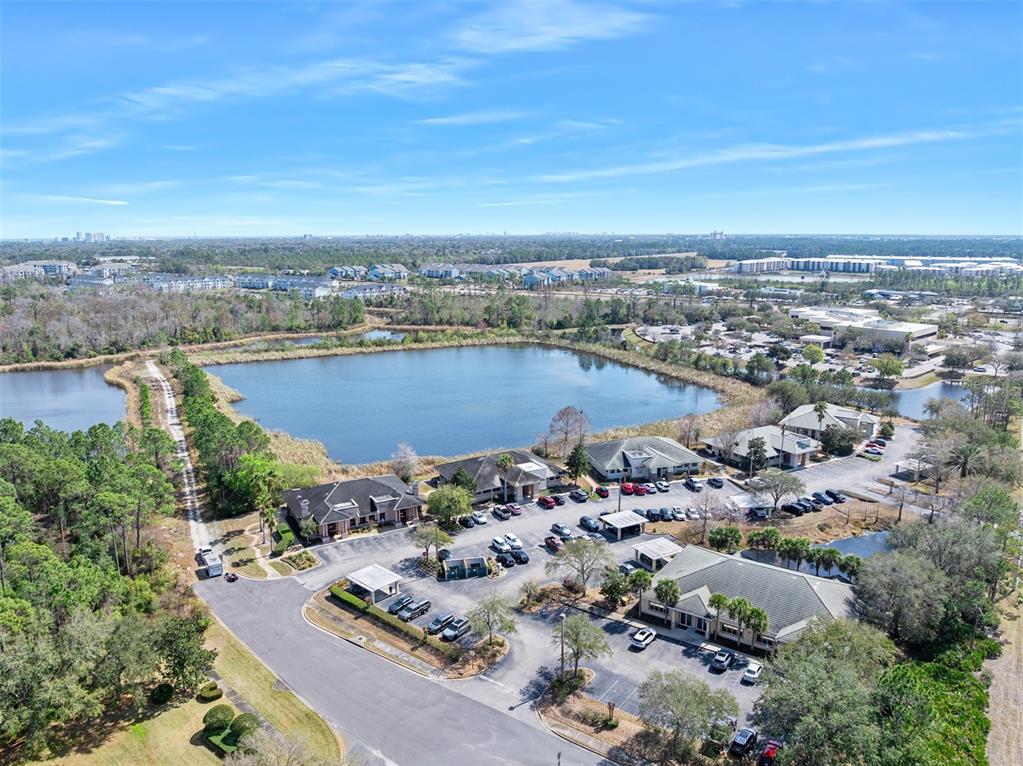 An aerial view shows a commercial office complex situated next to a large retention pond — 1667 N CLYDE MORRIS BOULEVARD, DAYTONA BEACH, FL