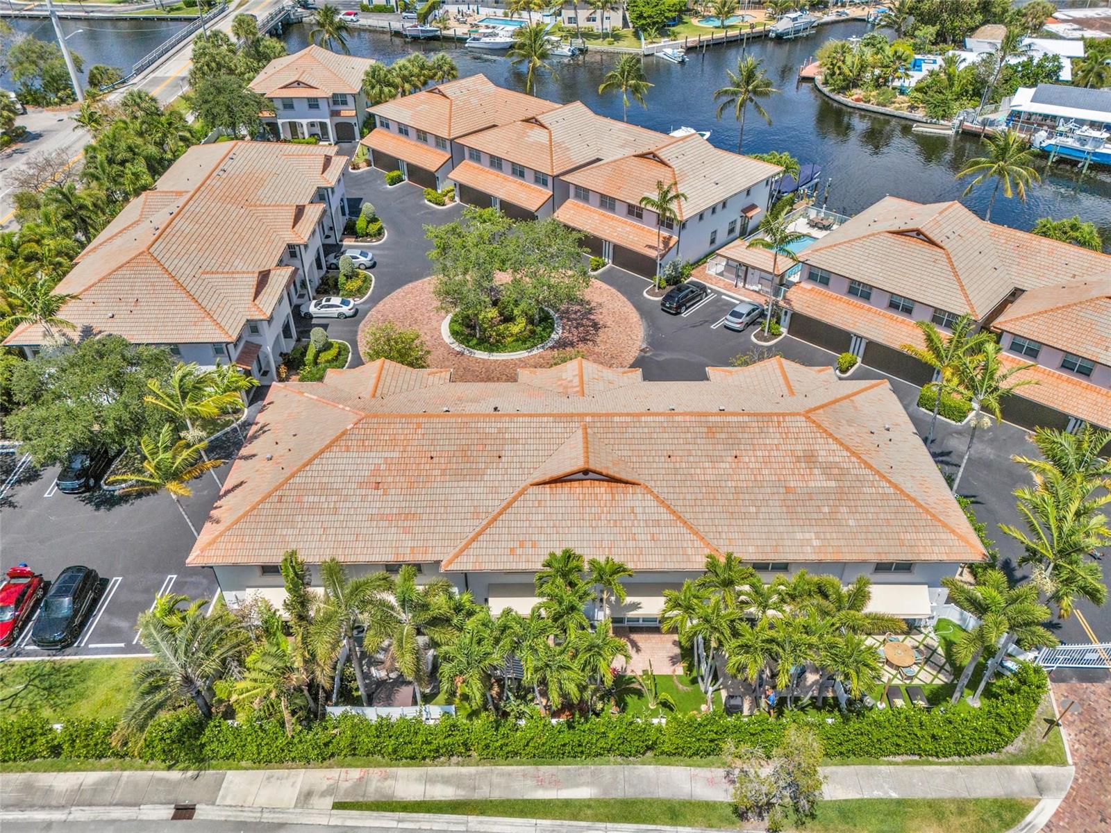 An aerial view of a residential complex with tile roofs, palm trees, and a canal — 1327 SE 3rd Avenue, Pompano Beach FL 33060, POMPANO BEACH, FL