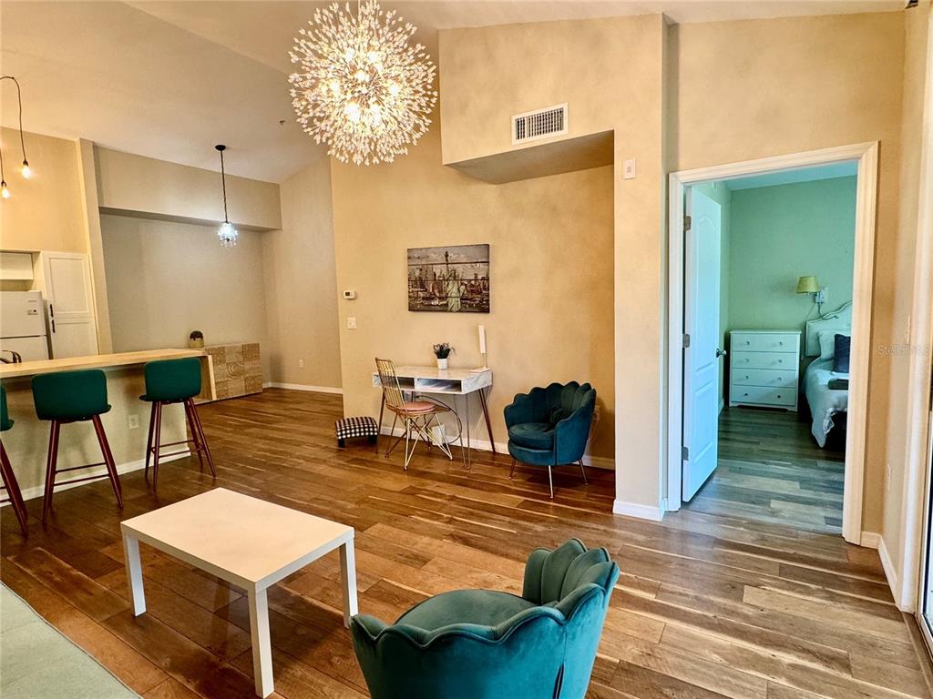 A multi-story apartment building with a covered parking area and large trees in front — 4106 CENTRAL SARASOTA PARKWAY UNIT # 1028, SARASOTA, FL