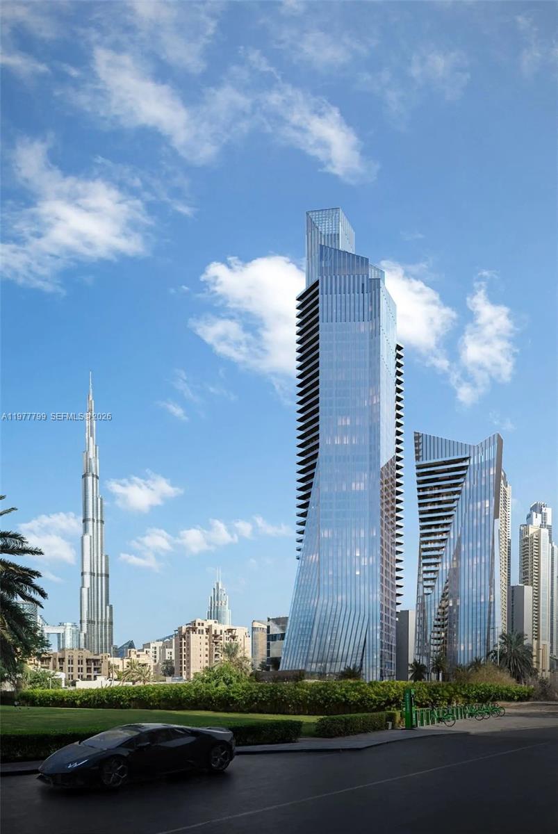This is an architectural rendering of modern skyscrapers in a city with a sports car — 2 Al Mustaqbal Street # 803, Dubai, FL