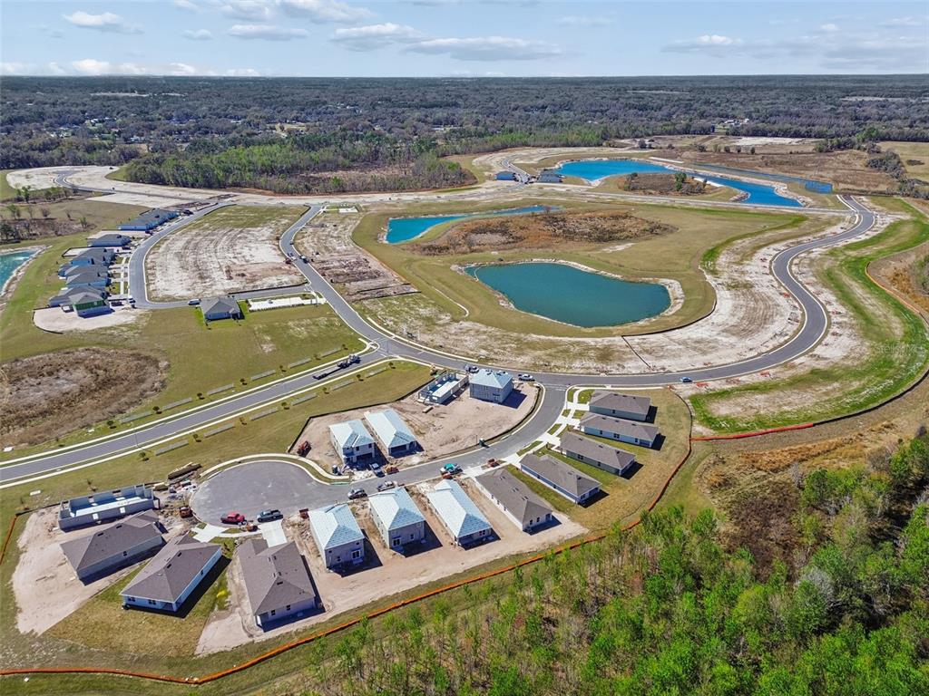 An aerial view shows a new residential development under construction with several completed houses — 4524 LAKE FOX DRIVE, LAKELAND, FL