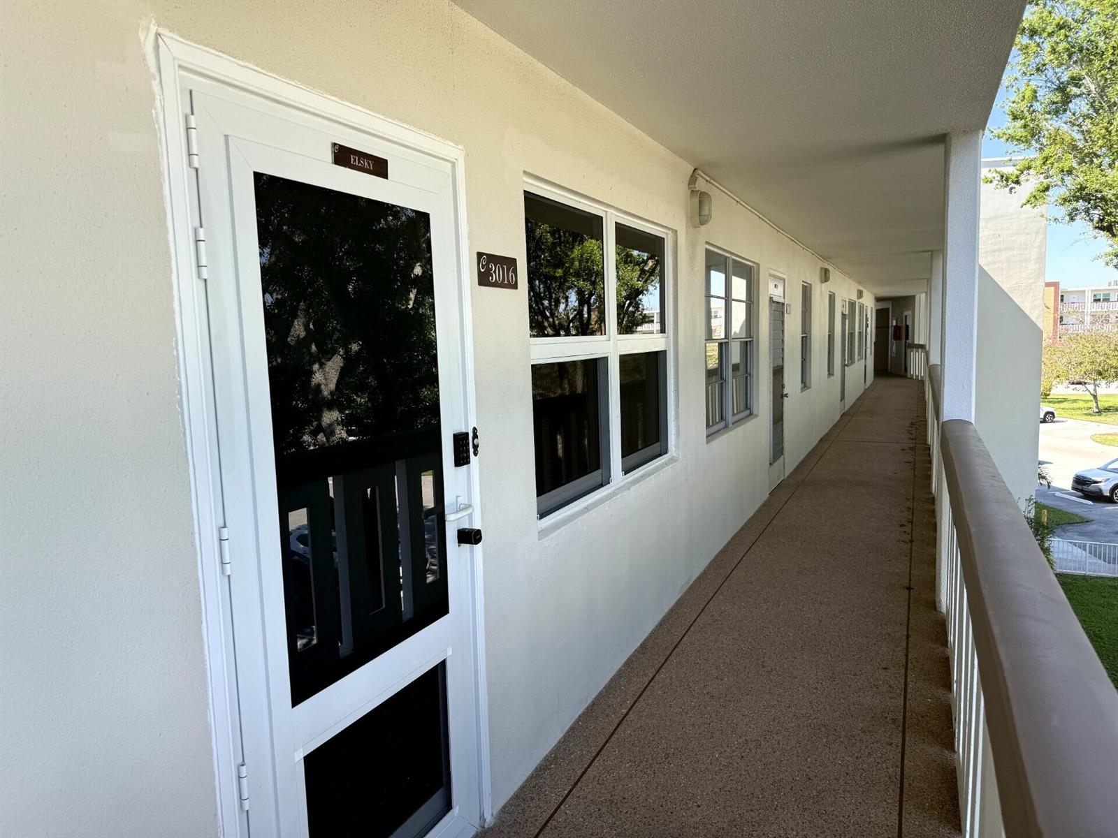 An exterior walkway leads past a white door labeled Elsky and unit number 3016 — 3016 Ashby C # 3016, Deerfield Beach FL 33442, DEERFIELD BEACH, FL