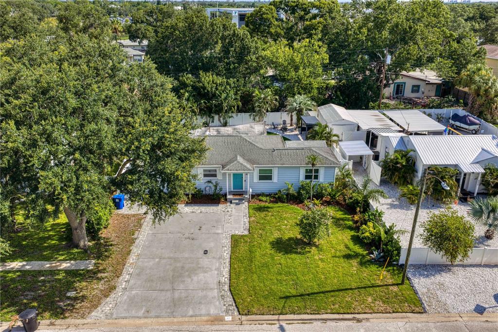 An aerial view shows a light blue single-story house with a concrete driveway and lawn — 417 HAMPTON AVENUE NE, ST PETERSBURG, FL