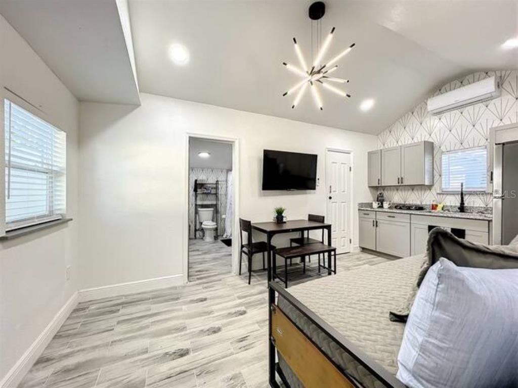 A studio apartment features a kitchenette, a dining area, and a bathroom entrance — 2008 PAGE AVE UNIT 2, ORLANDO, FL