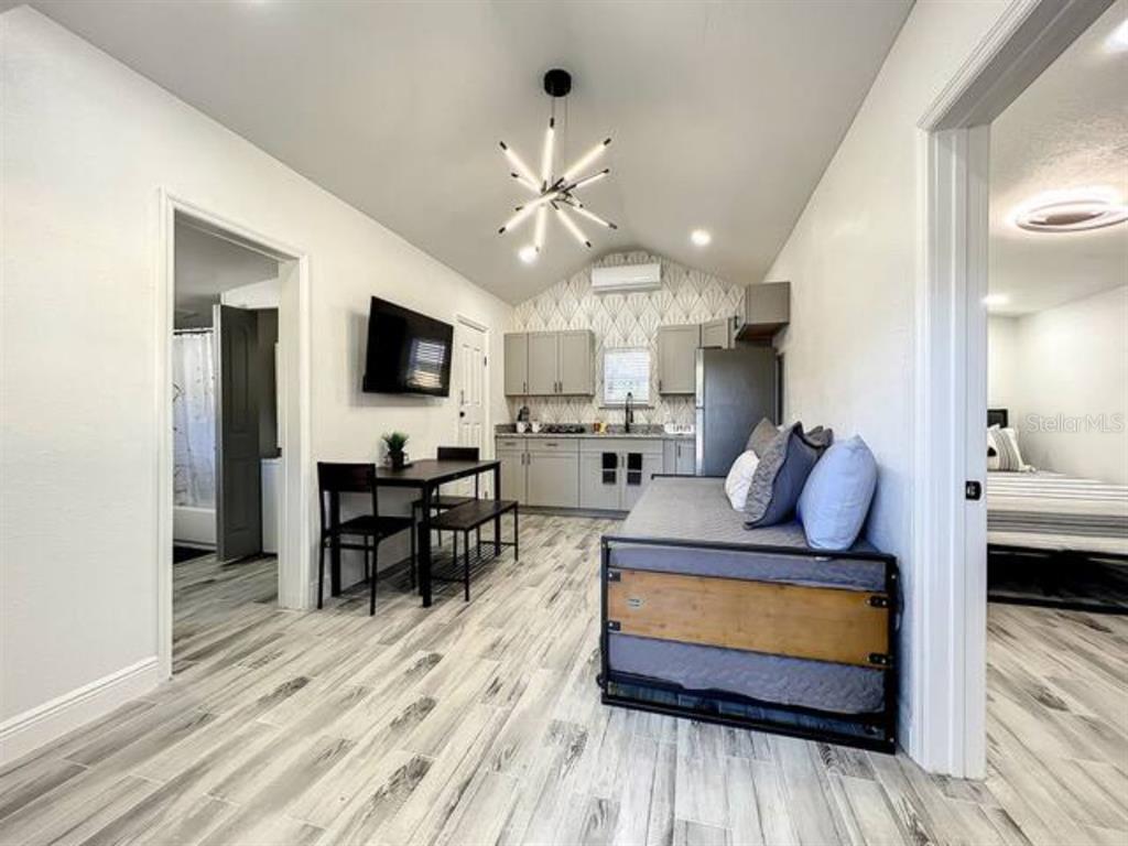 A small studio apartment features a kitchenette, a dining table, and a daybed — 2008 PAGE AVE UNIT 2, ORLANDO, FL