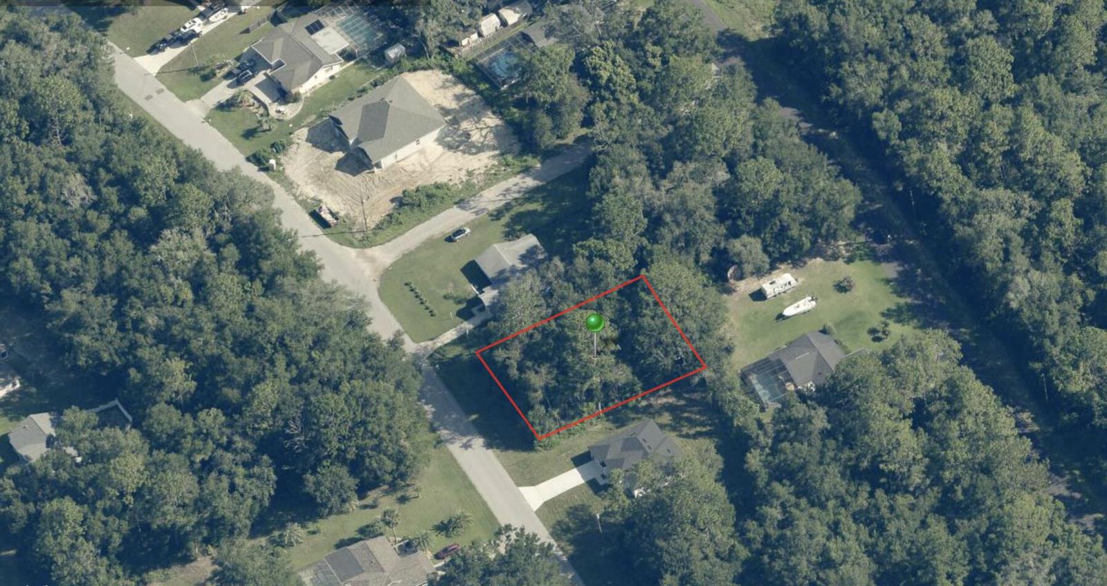 An aerial view shows a rectangular vacant lot outlined in red within a wooded neighborhood — 8525 N Golfview Drive, FL 34434, FL
