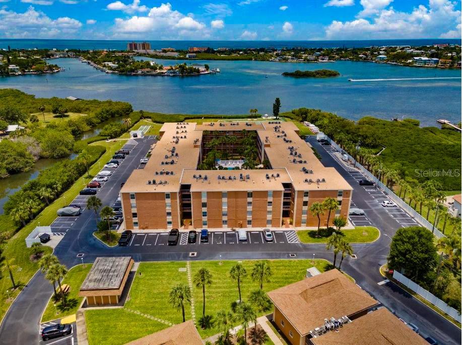 An aerial view shows a large, rectangular apartment complex with a central courtyard and parking — 12760 INDIAN ROCKS ROAD UNIT 1110, LARGO, FL