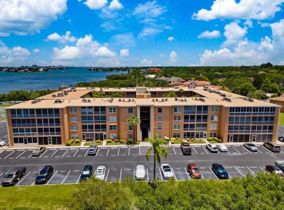 An aerial view of a multi-story apartment building with a parking lot in front — 12760 INDIAN ROCKS ROAD UNIT 1110, LARGO, FL