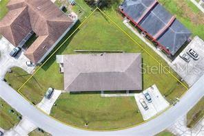 An aerial view shows a single-story house with a hip roof on a triangular lot — 858 FOX LAKE DRIVE UNIT 858, LAKELAND, FL