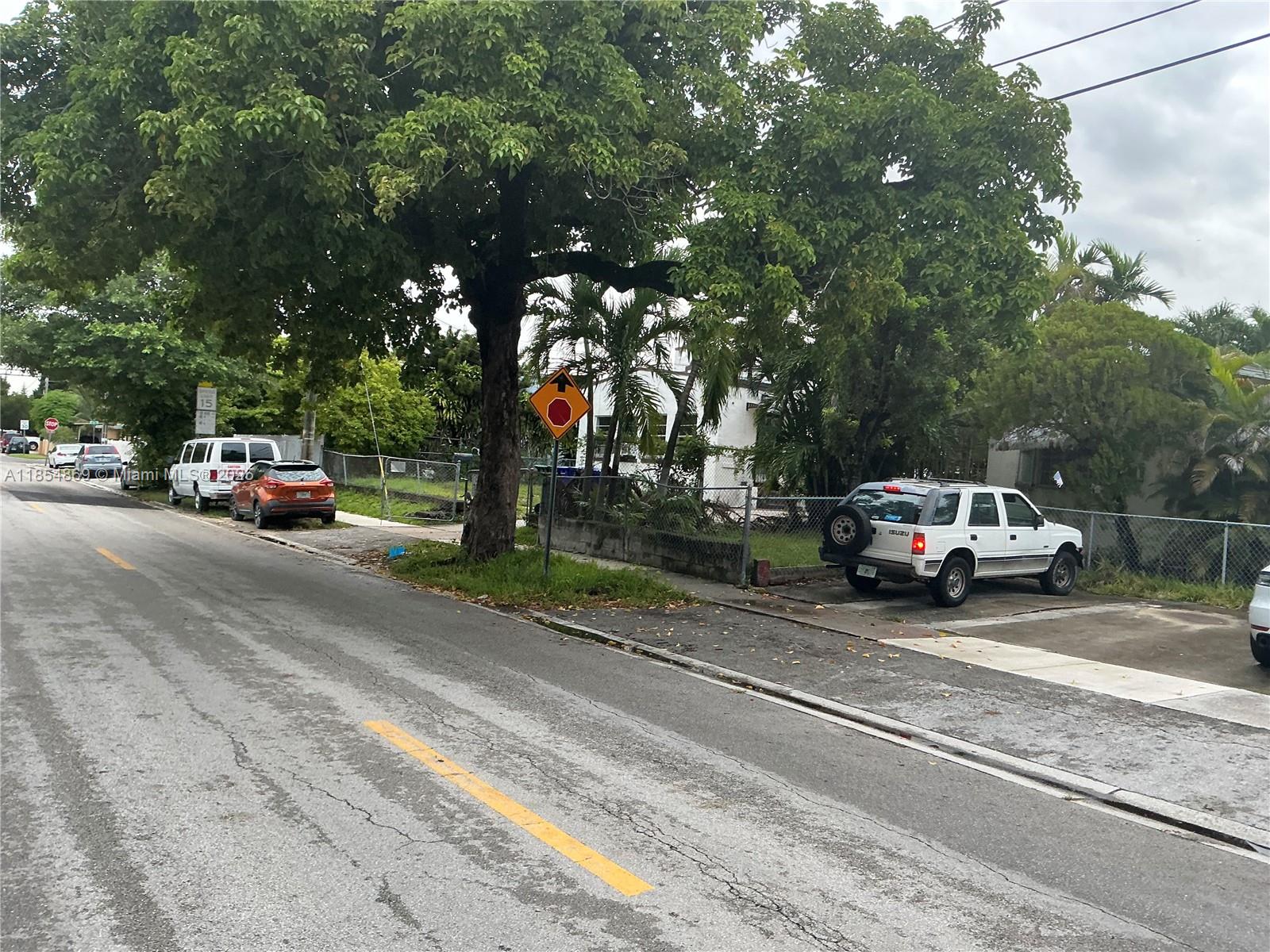 A street view shows a white SUV parked in a driveway beside a large tree — 1855 NW 32nd St, Miami FL 33142, MIAMI, FL
