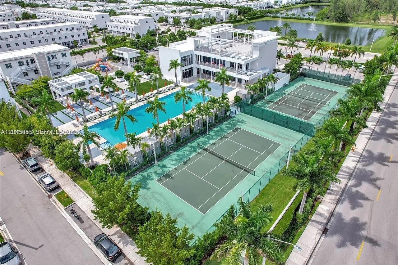 An aerial view shows a swimming pool, two tennis courts, and a clubhouse — 6319 NW 105 CT # 0, Doral FL 33178, DORAL, FL