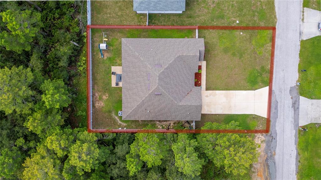 An aerial view shows a house with a fenced backyard and a concrete driveway — 236 ELM COURT, KISSIMMEE, FL