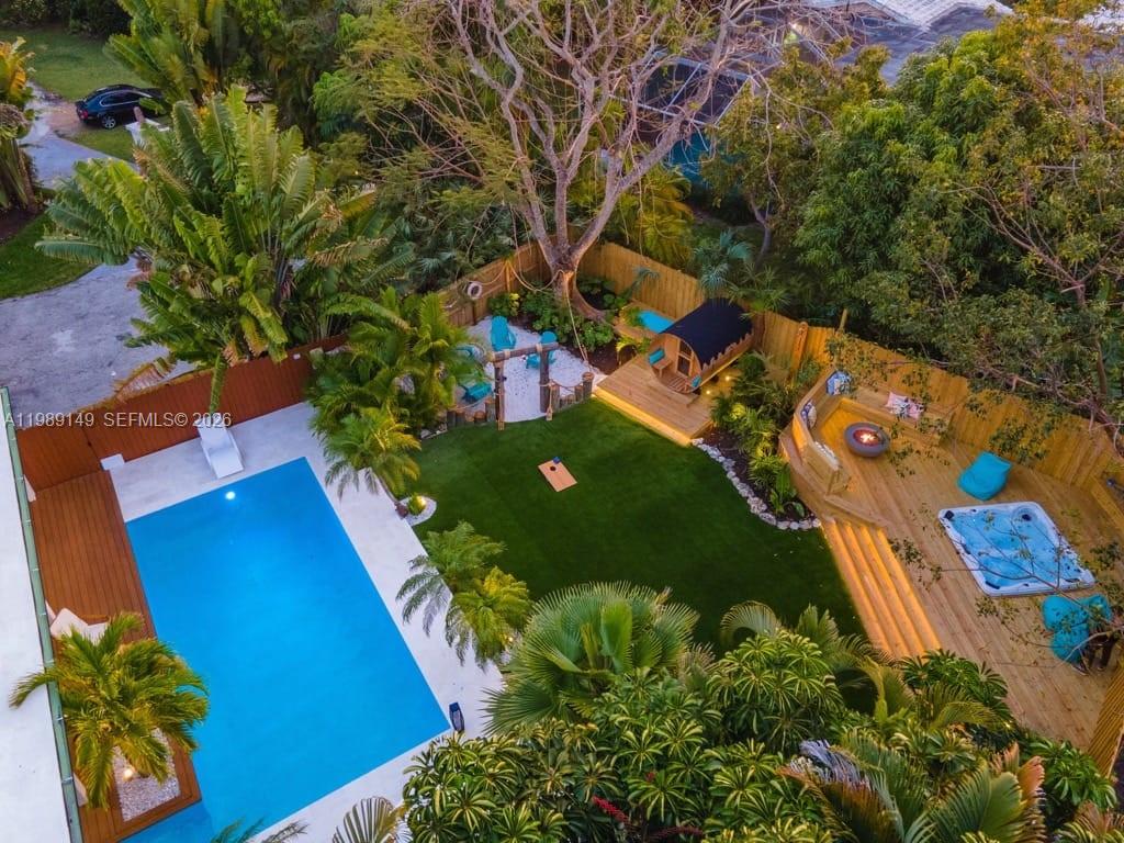 An aerial view of a backyard featuring a swimming pool, hot tub, and fire pit — 18490 SW 83rd Pl, Cutler Bay FL 33157, CUTLER BAY, FL