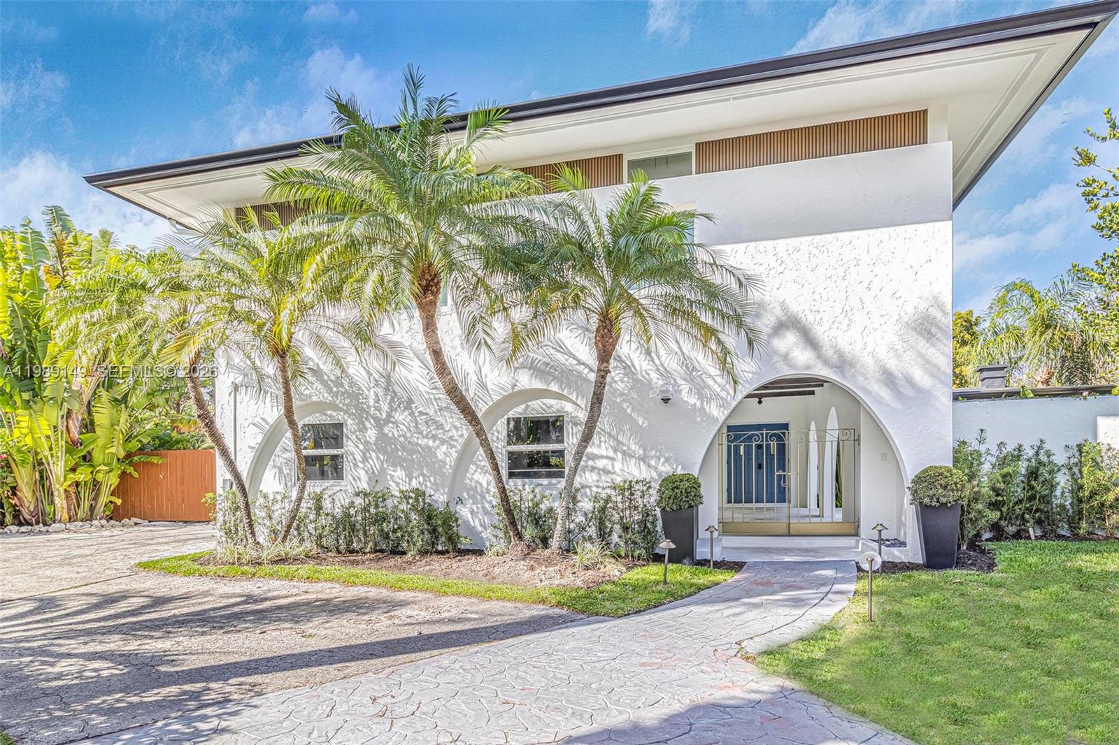 A two-story white house features arched entryways, palm trees, and a stone-paved walkway — 18490 SW 83rd Pl, Cutler Bay FL 33157, CUTLER BAY, FL
