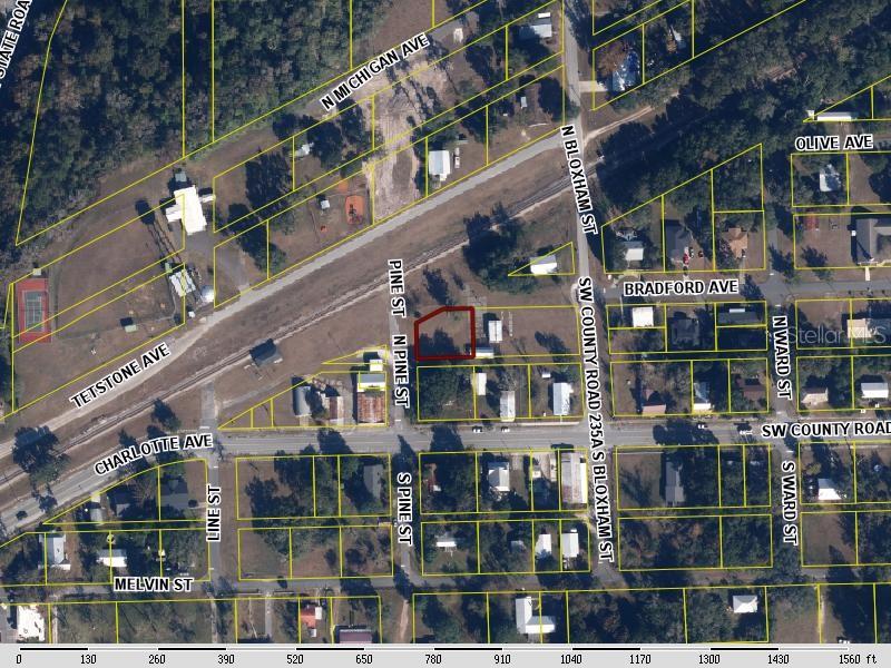This is an aerial map showing a vacant lot outlined in red near local streets — BRADFORD AVENUE, BROOKER, FL