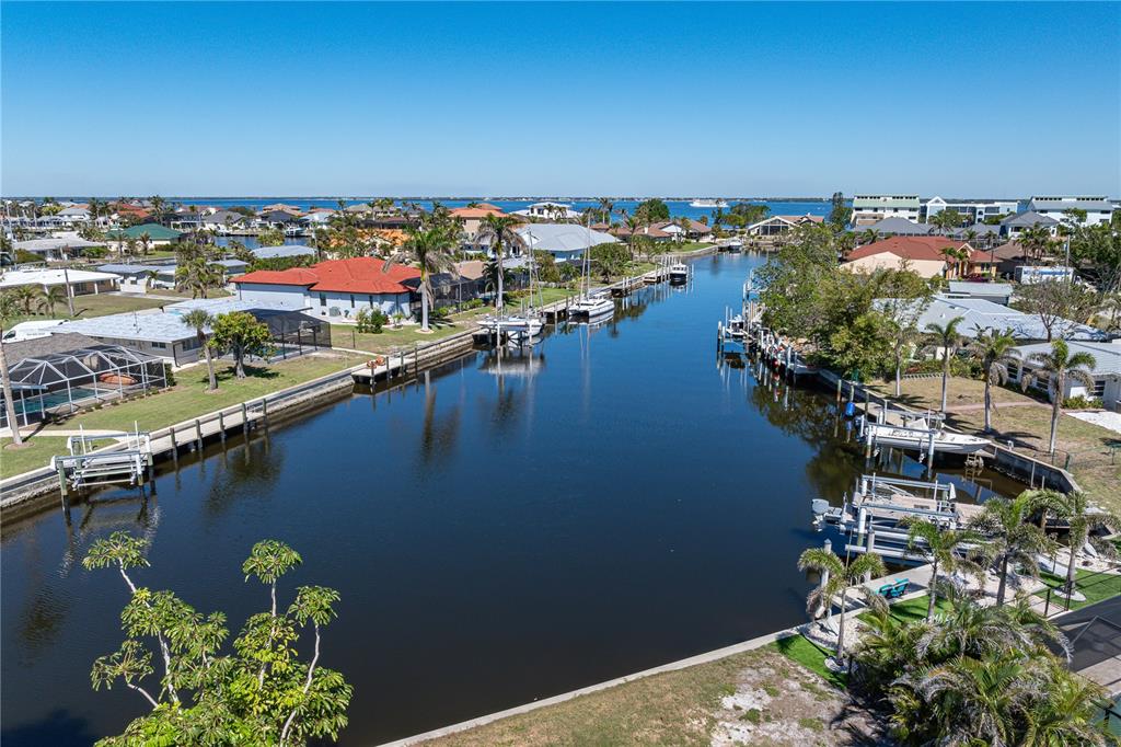 An aerial view of a residential canal lined with houses, docks, and boats — 1940 W MARION AVENUE, PUNTA GORDA, FL