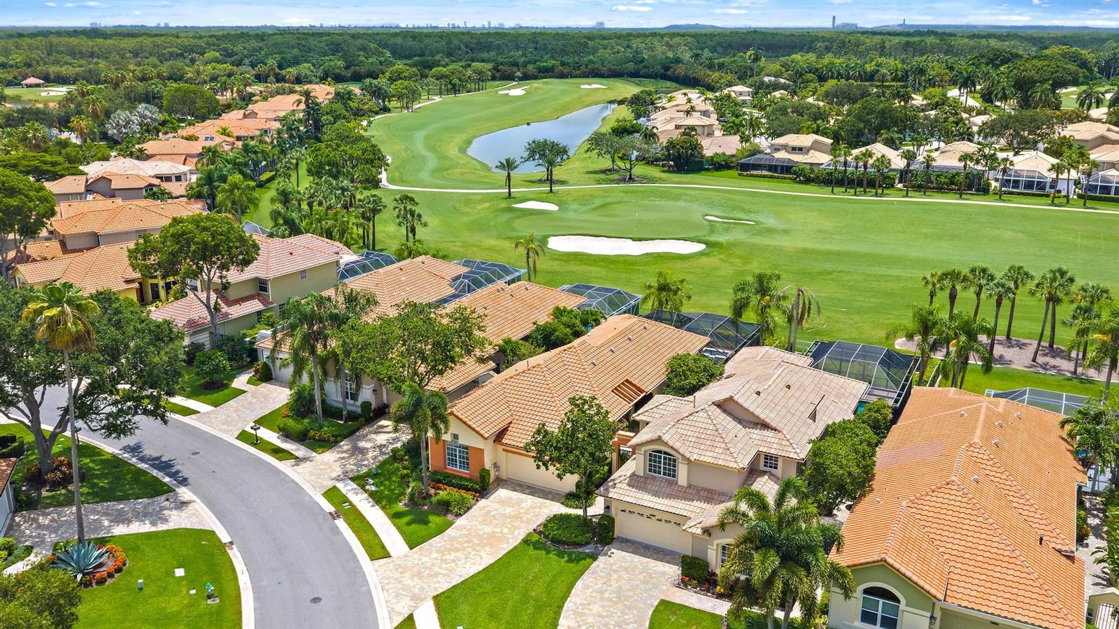 An aerial view shows a suburban neighborhood with tile-roofed houses bordering a golf course — 10350 Osprey Trace, West Palm Beach FL 33412, WEST PALM BEACH, FL