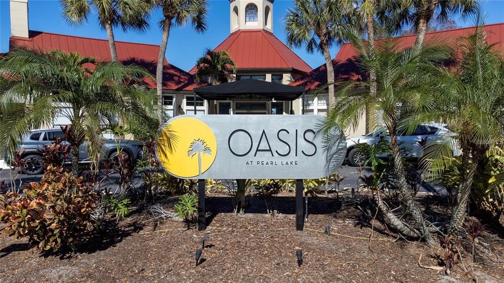 A sign for Oasis at Pearl Lake stands in front of a building with palm trees — 199 AFTON SQUARE UNIT 308, ALTAMONTE SPRINGS, FL