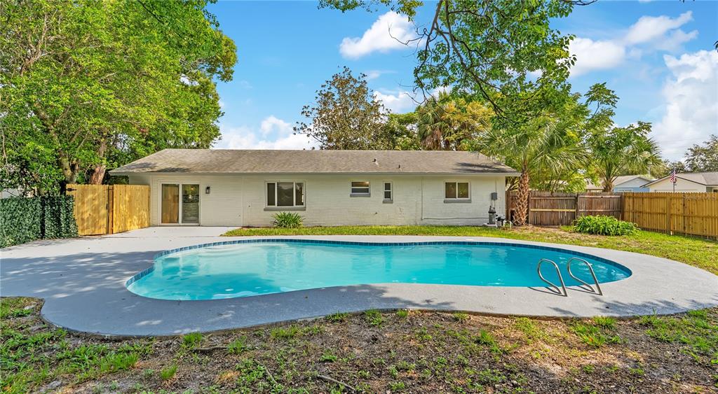 A backyard patio features a swimming pool, outdoor seating, a fire pit, and dining area — 779 PARK MANOR DRIVE, ORLANDO, FL