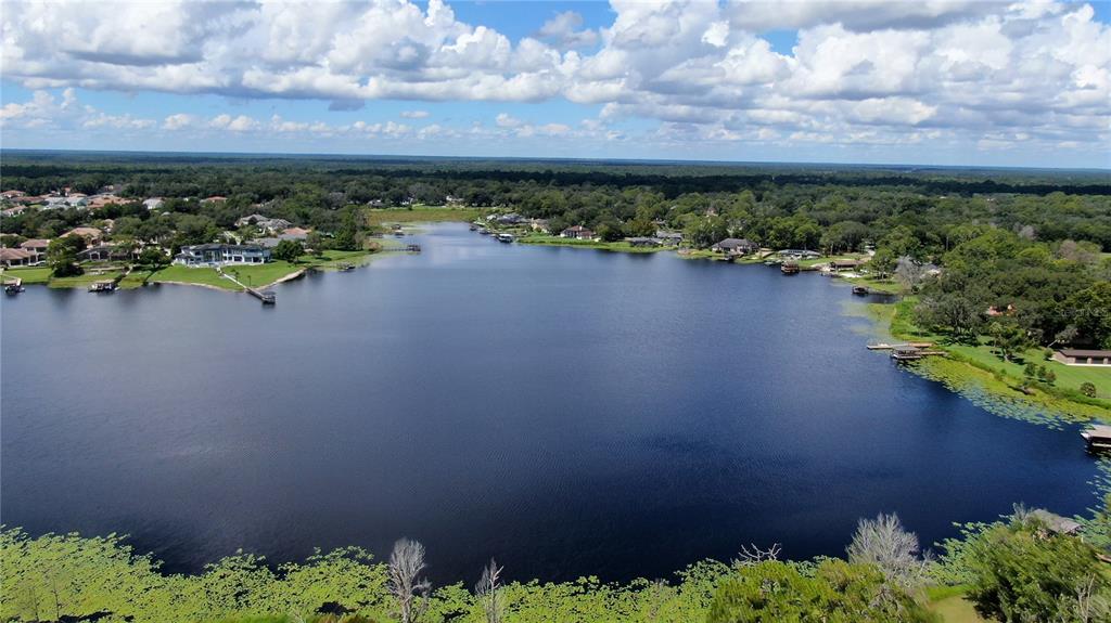 An aerial view of a large lake surrounded by residential homes and lush green trees — 800 LAKE MARKHAM ROAD, SANFORD, FL
