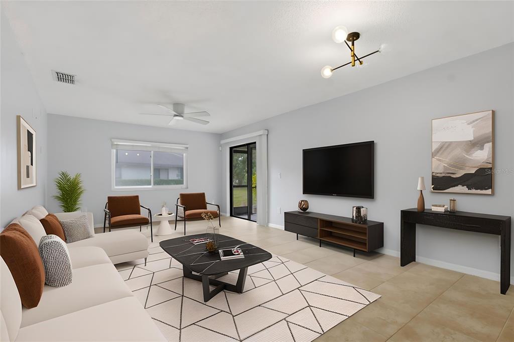 This is a digital rendering of a modern living room with a sofa, chairs, and television — 2701 COUNTRYSIDE BOULEVARD UNIT 102, CLEARWATER, FL