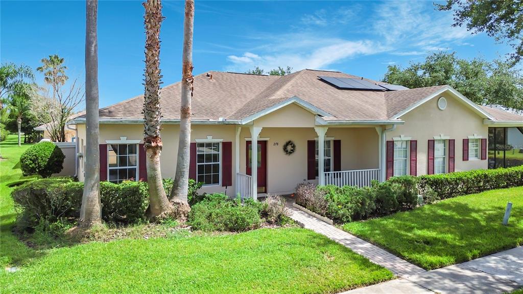 A single-story house with a tan exterior, red shutters, and palm trees in the front yard — 278 ANASTASIA DRIVE, KISSIMMEE, FL