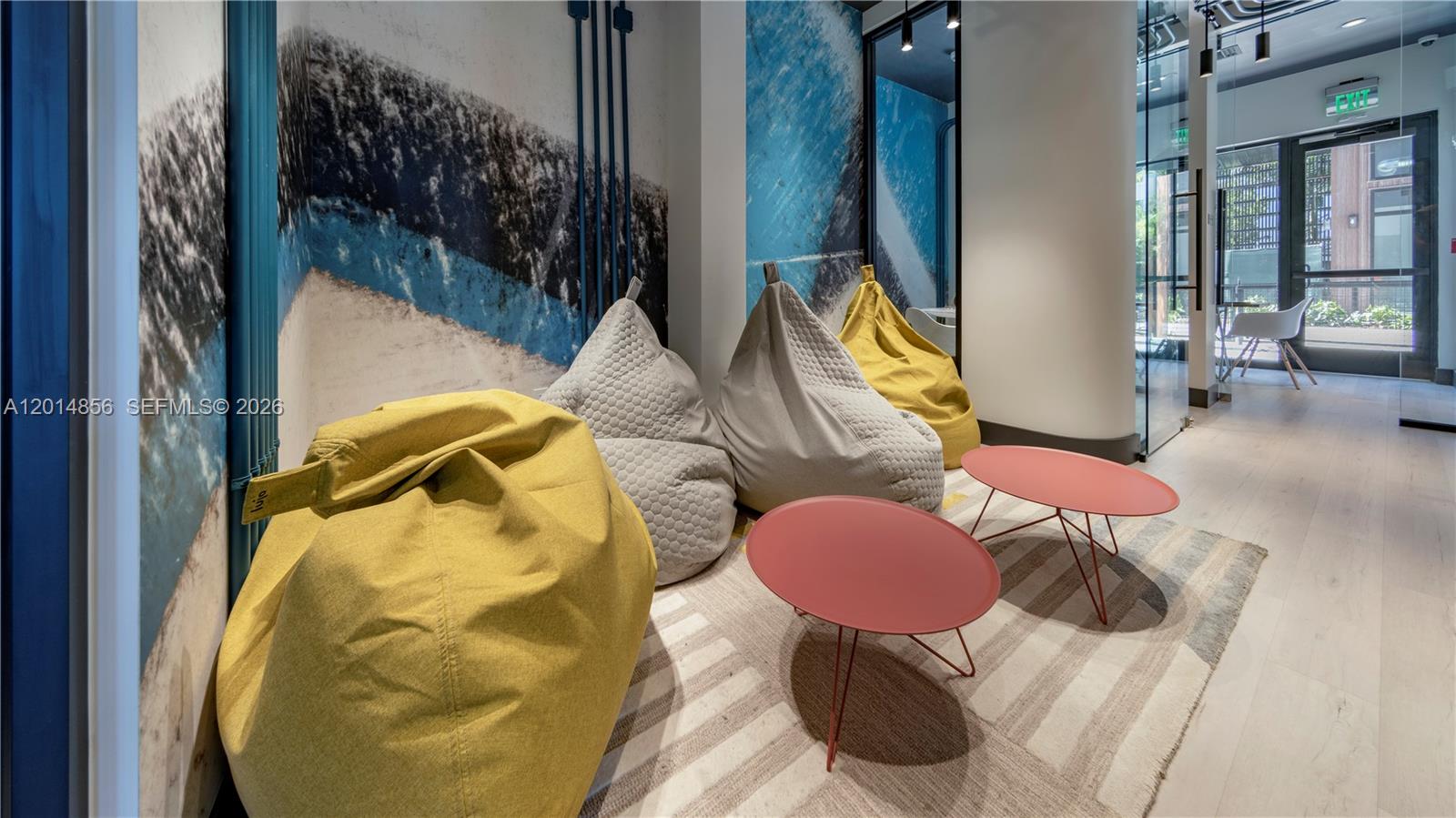 A lounge area features four beanbag chairs, two small round tables, and a striped rug — 6970 SW 40th St # 302, Miami FL 33155, MIAMI, FL