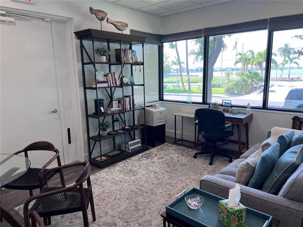 A home office features a bookshelf, a desk by a window, and a seating area — 515 W BAY STREET UNIT 100, 101, TAMPA, FL
