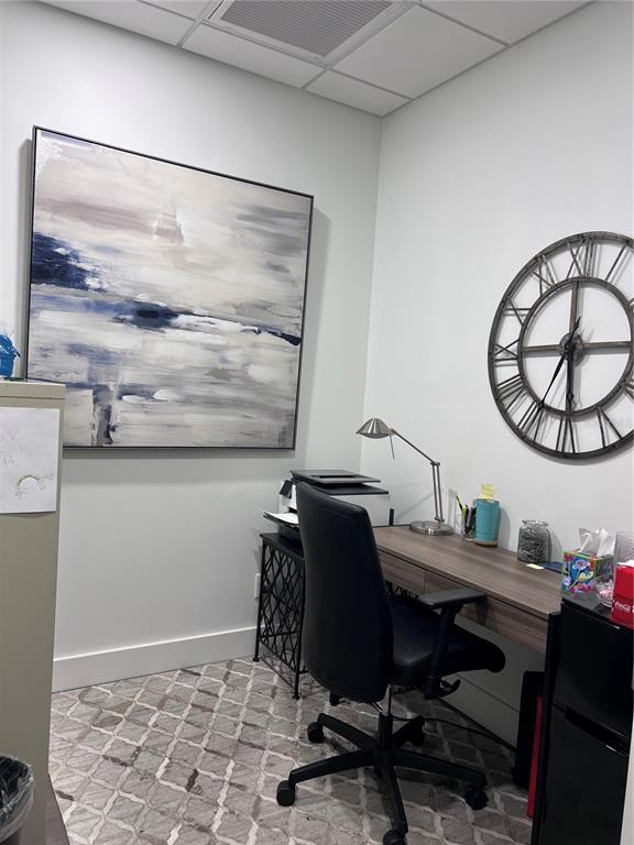 A home office features a desk, black chair, large abstract painting, and wall clock — 515 W BAY STREET UNIT 100, 101, TAMPA, FL