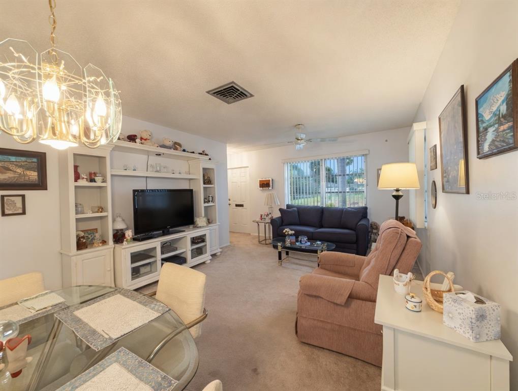 A living room features a dining area, a television console, a sofa, and a recliner — 2225 ORANGE BLOSSOM LANE, BRADENTON, FL