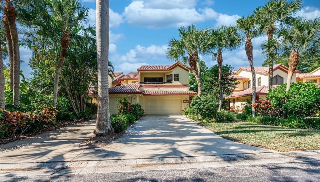 A two-story house with a beige exterior, a two-car garage, and palm trees in front — 5425 10th Fairway Drive # 3, Delray Beach FL 33484, DELRAY BEACH, FL