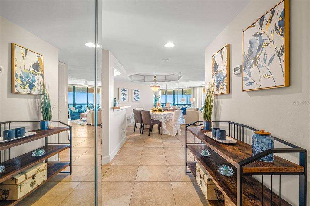 A tiled entryway leads into a dining area and living room with floor-to-ceiling windows — 1310 GULF BOULEVARD UNIT 10D, CLEARWATER BEACH, FL