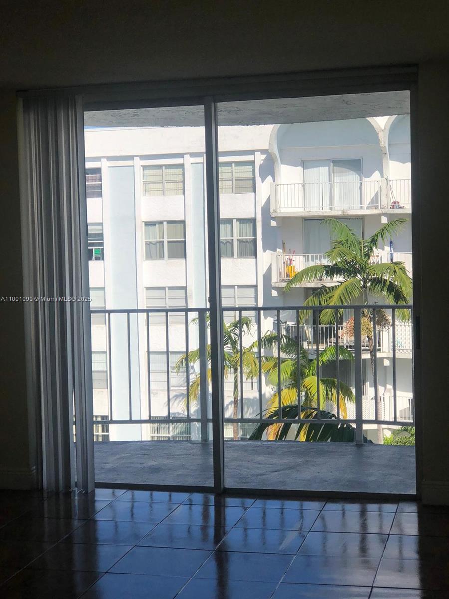 A view from a tiled room through a sliding glass door onto a balcony — 492 NW 165th St Rd # C514, Miami FL 33169, MIAMI, FL