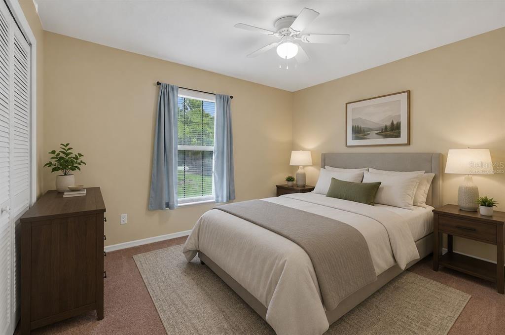 A bedroom features a bed, two nightstands, a dresser, a window, and a ceiling fan — 1520 3RD AVENUE, DELAND, FL