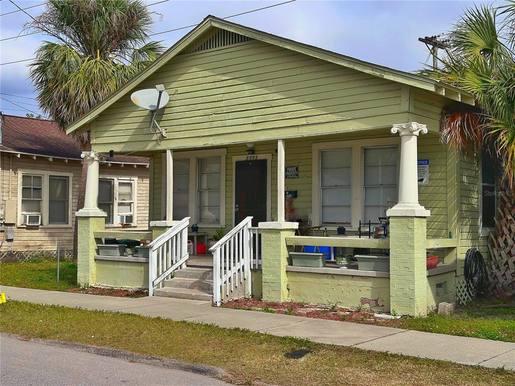 A light green, single-story house features a front porch with white columns and stairs — 2001 N 25TH STREET, TAMPA, FL