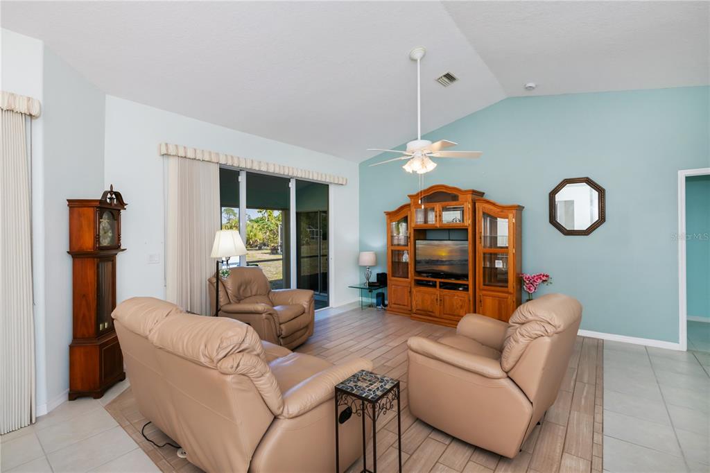 An aerial view shows a single-story house with a white roof on a large lot — 409 BOUNDARY BOULEVARD, ROTONDA WEST, FL