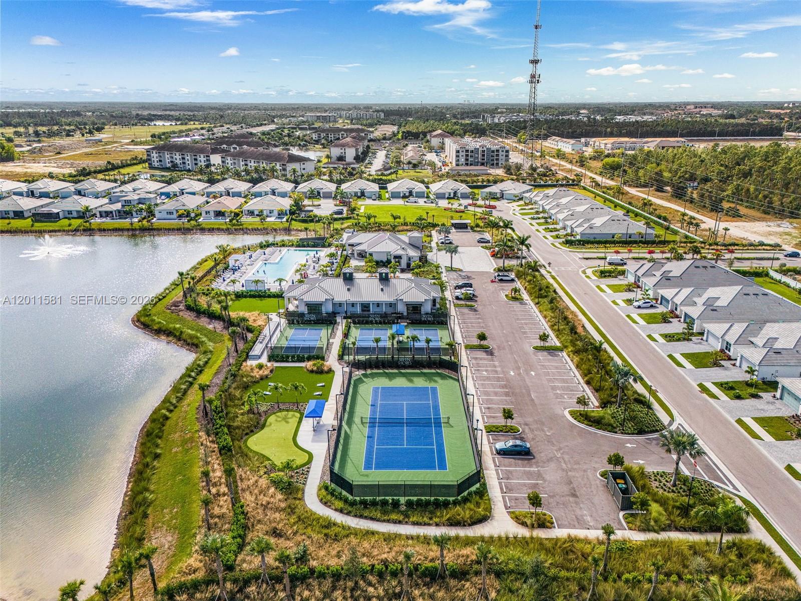 An aerial view shows a community clubhouse with a pool, tennis courts, and parking — 9087 Kite Ln, Naples FL 34114, NAPLES, FL