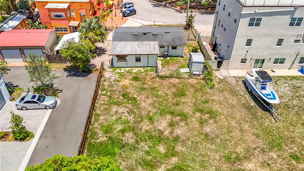 An aerial view shows a vacant lot with a small house, shed, and parked boat — 2304 N HIGHLAND AVENUE, TAMPA, FL