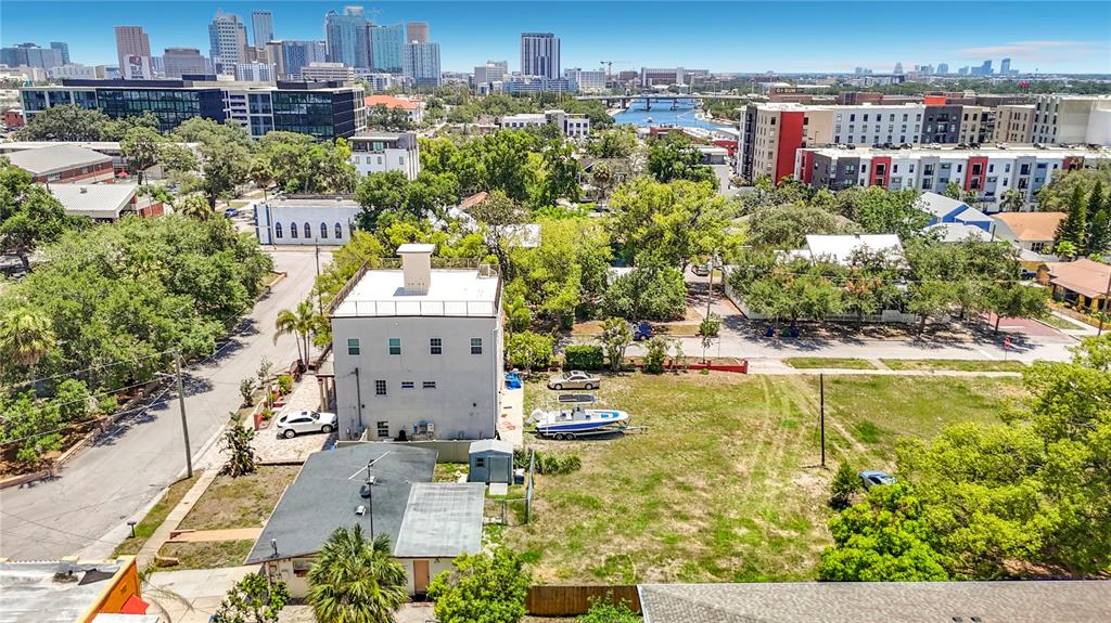 An aerial view shows a multi-story building, a small house, and a vacant lot — 2304 N HIGHLAND AVENUE, TAMPA, FL