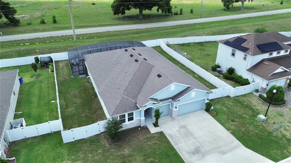 An aerial view shows a single-story house with a pool enclosure and a white fence — 4710 SW 65TH PLACE, OCALA, FL