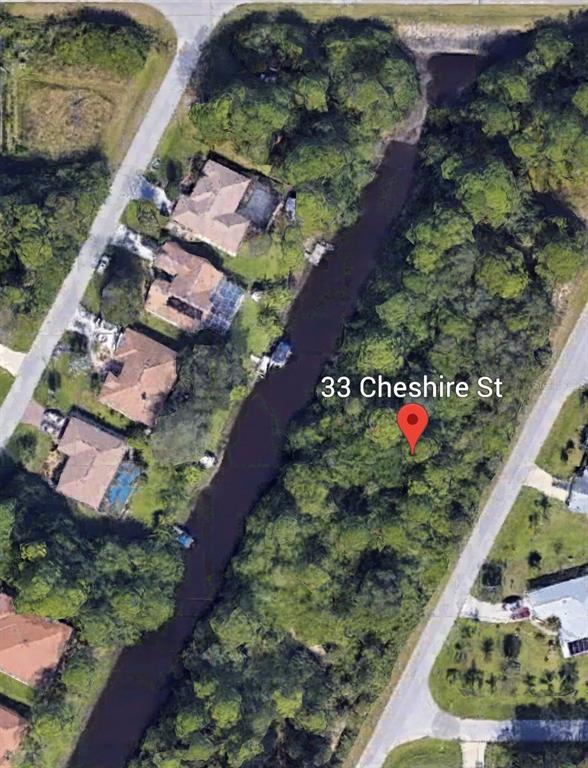 An aerial map view shows a vacant wooded lot situated next to a canal — 33 CHESHIRE STREET, PORT CHARLOTTE, FL