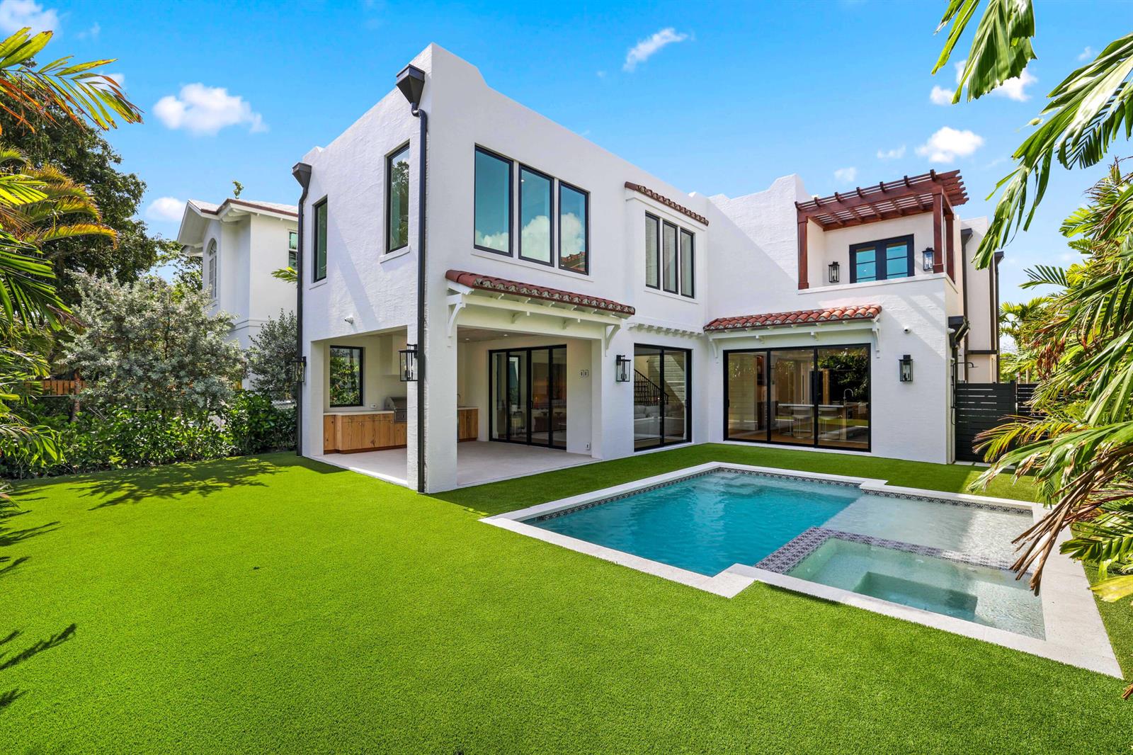 A white two-story house with a pool, covered patio, and artificial turf lawn — 317 Greymon Drive, West Palm Beach FL 33405, WEST PALM BEACH, FL