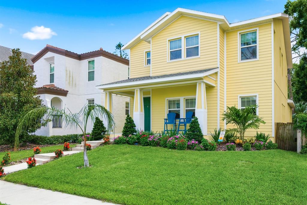A yellow two-story house with a front porch and a green lawn — 4920 3RD STREET N, ST PETERSBURG, FL