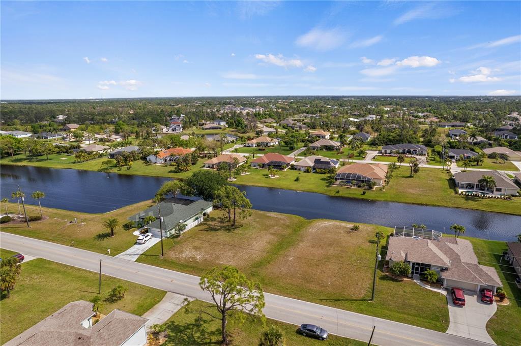 An aerial view shows houses along a canal in a suburban neighborhood — 805 ROTONDA CIRCLE, ROTONDA WEST, FL