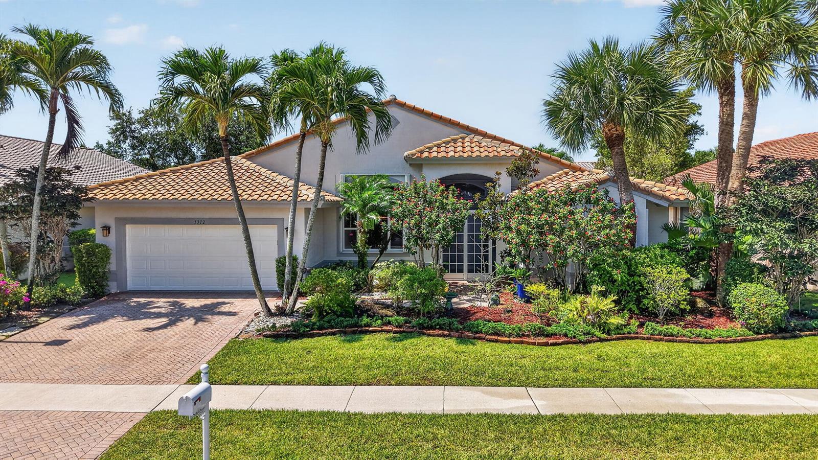 A single-story house with a tiled roof, a two-car garage, and palm trees in front — 5312 Brooklawn Terrace, Boynton Beach FL 33437, BOYNTON BEACH, FL