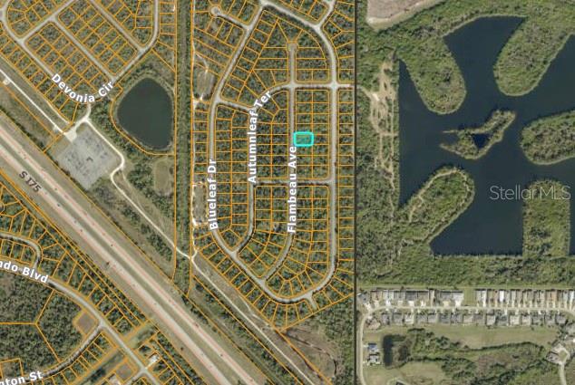 This is an aerial map showing a residential lot highlighted in blue within a neighborhood — FLAMBEAU AVENUE, NORTH PORT, FL