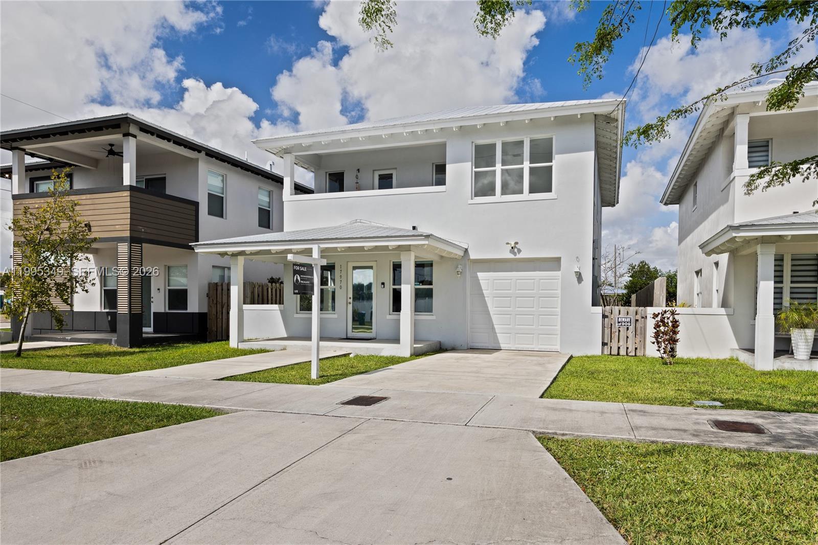 A two-story white house with a covered front porch and an attached single-car garage — 17970 SW 105th Ave, Miami FL 33157, MIAMI, FL