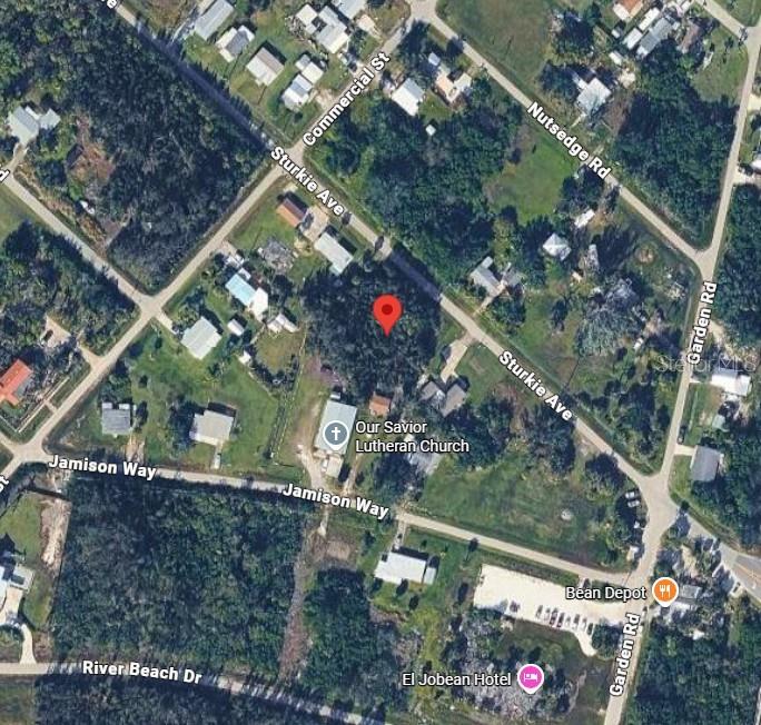 This is an aerial map view showing a wooded lot near a church and local roads — 4473 STURKIE AVENUE, PORT CHARLOTTE, FL